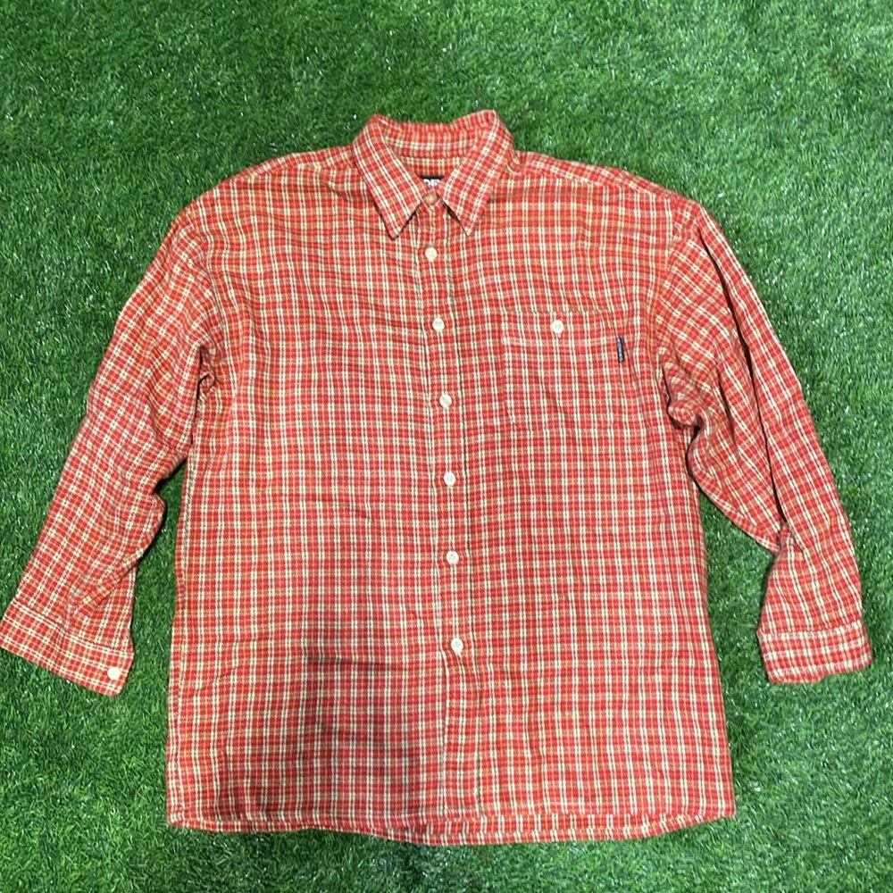 Men’s long sleeve red and green plaid button up shirt.